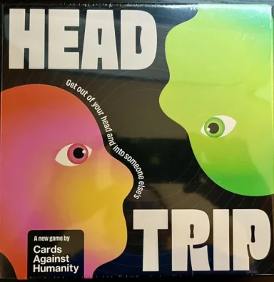 Head Trip* A red and orange head silhouette with an eye looks at an upside down green head silhouette with an eye between the words "Head Trip"